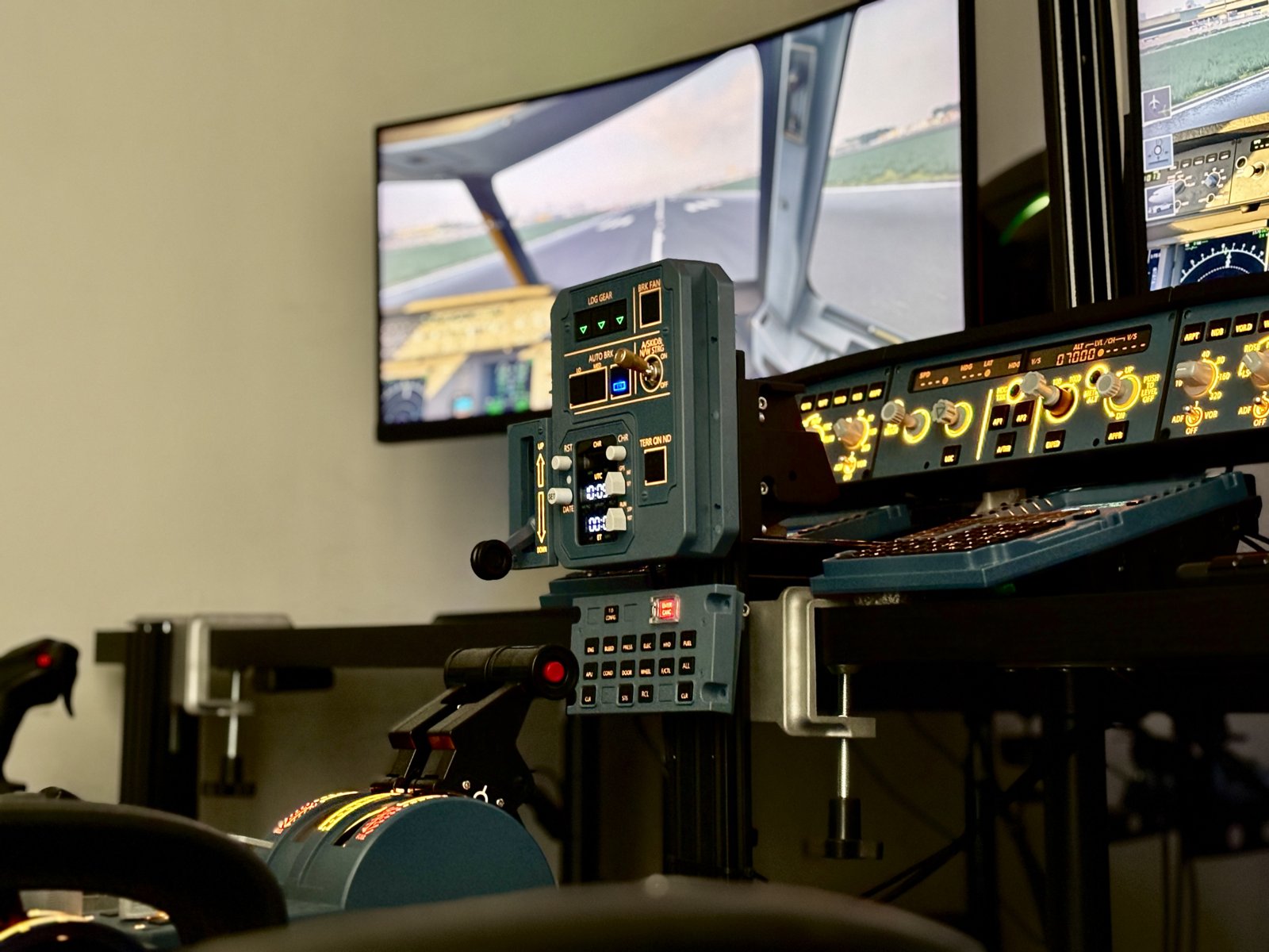 The A320 Aviation Simulator Station with its instrument displays lit and the outside visual running.