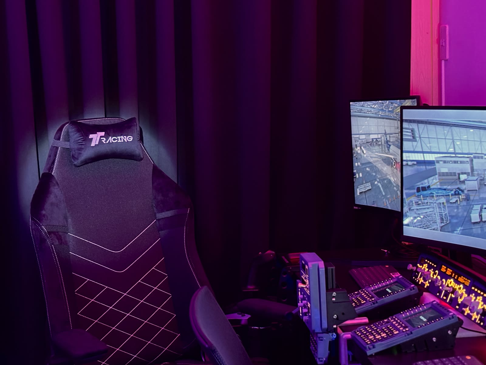The Aviation Simulator Station cockpit rig with racing-style seats and instrument displays lit up.
